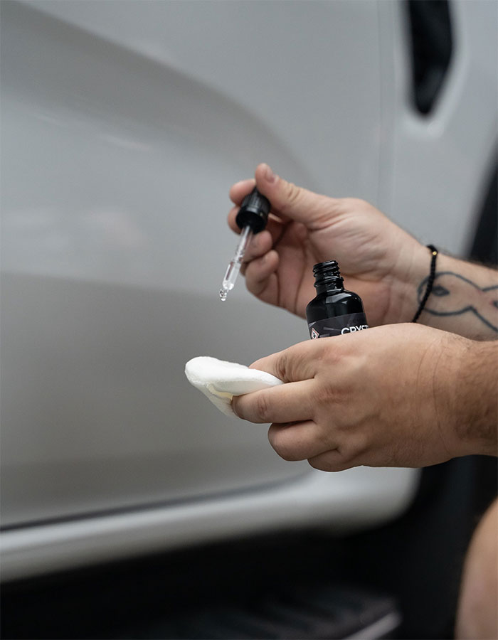 Clay bar being used to decontaminate vehicle paint